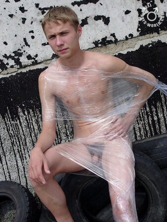 Naked Max enjoys playing with tires in the sun