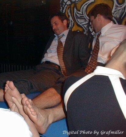 Men in suits gather for a thrilling foot fetish party