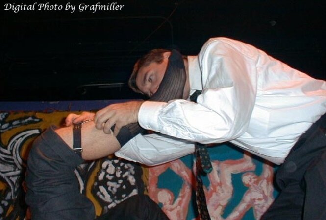 Men in suits gather for a thrilling foot fetish party