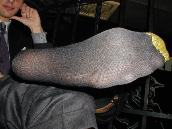 Men in suits gather for a thrilling foot fetish party