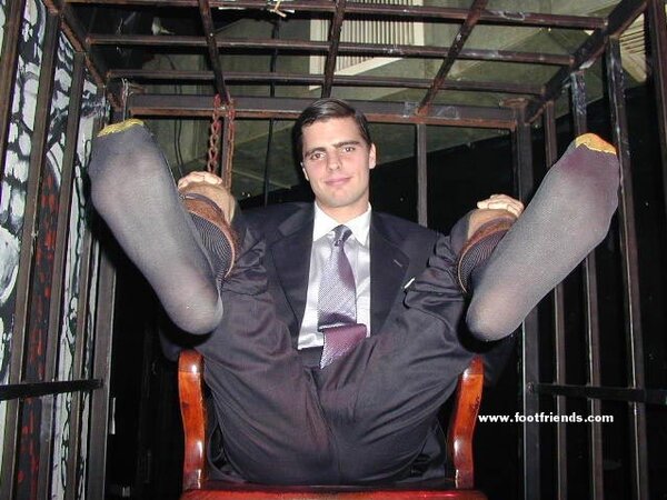 Men in suits gather for a thrilling foot fetish party