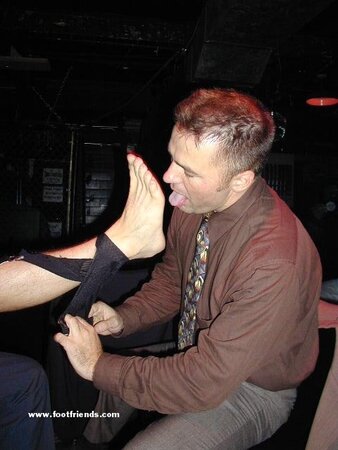 Men in suits gather for a thrilling foot fetish party