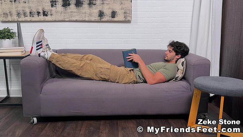Zeke Stone props his size 10 feet while reading