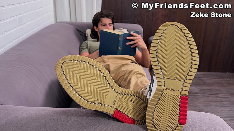 Zeke Stone props his size 10 feet while reading