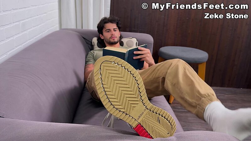 Zeke Stone props his size 10 feet while reading