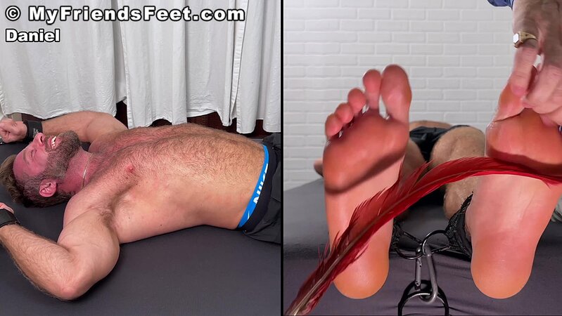 Daniel squirms as Dan Edwards tickles his bare feet