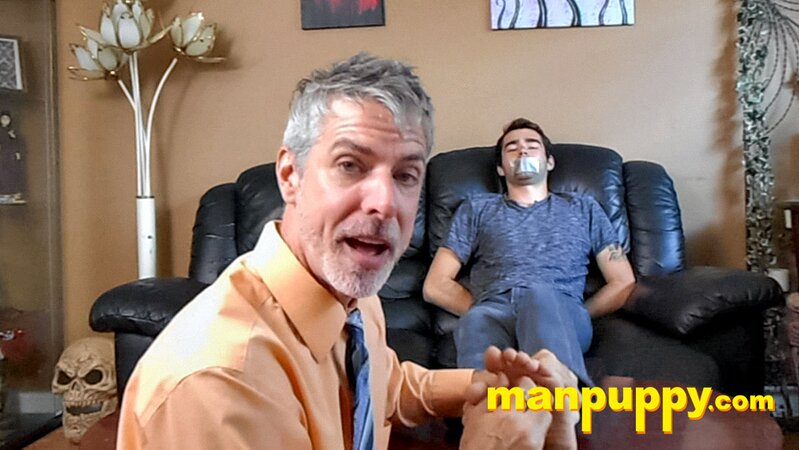 Kody Tracer squirms as Richard Lennox tickles with brush