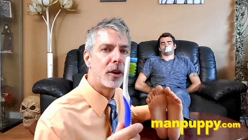 Kody Tracer squirms as Richard Lennox tickles with brush