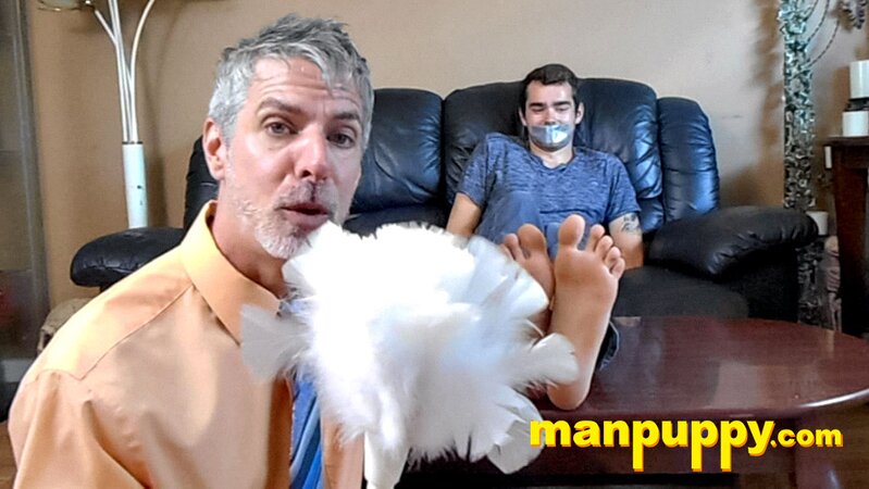 Kody Tracer squirms as Richard Lennox tickles with brush
