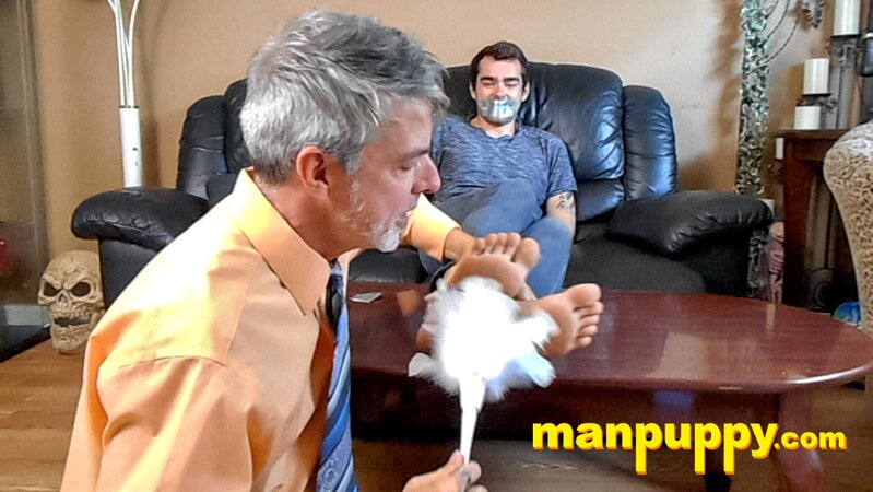 Kody Tracer squirms as Richard Lennox tickles with brush
