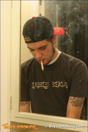Zack smokes a cigarette while shaving in bathroom