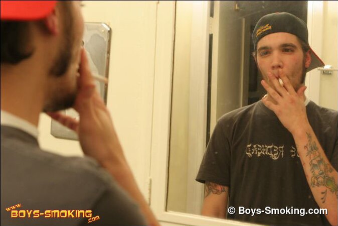 Zack smokes a cigarette while shaving in bathroom