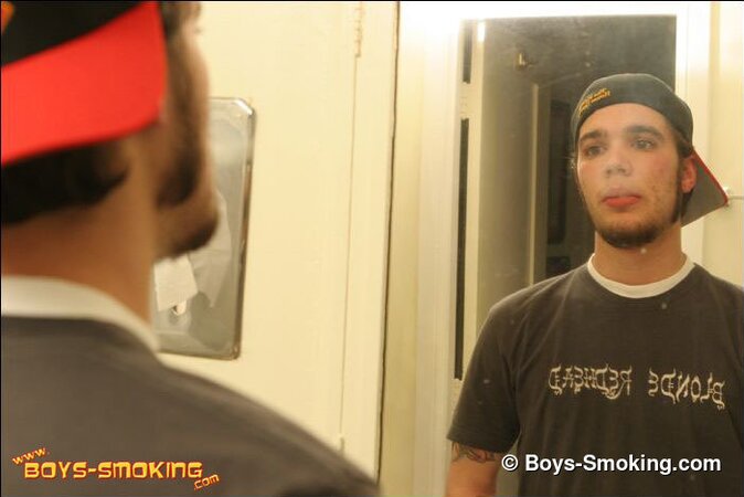 Zack smokes a cigarette while shaving in bathroom