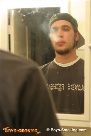 Zack smokes a cigarette while shaving in bathroom