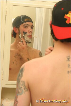 Zack smokes a cigarette while shaving in bathroom