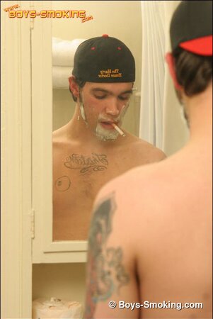 Zack smokes a cigarette while shaving in bathroom
