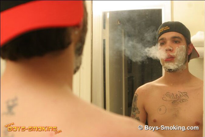 Zack smokes a cigarette while shaving in bathroom