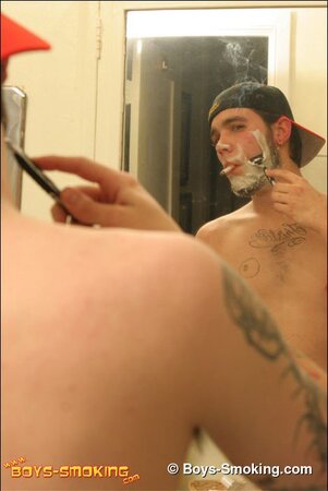 Zack smokes a cigarette while shaving in bathroom