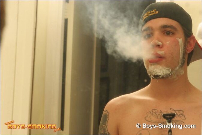 Zack smokes a cigarette while shaving in bathroom