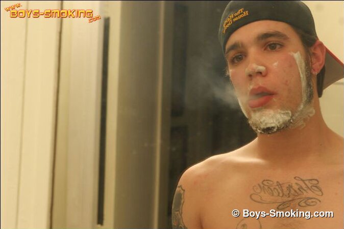 Zack smokes a cigarette while shaving in bathroom