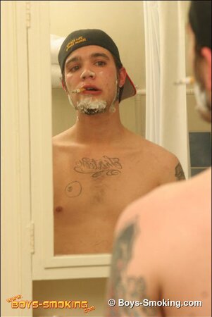 Zack smokes a cigarette while shaving in bathroom