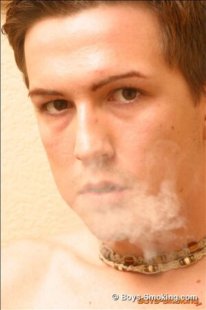 Joshua strips and strokes his cock while smoking